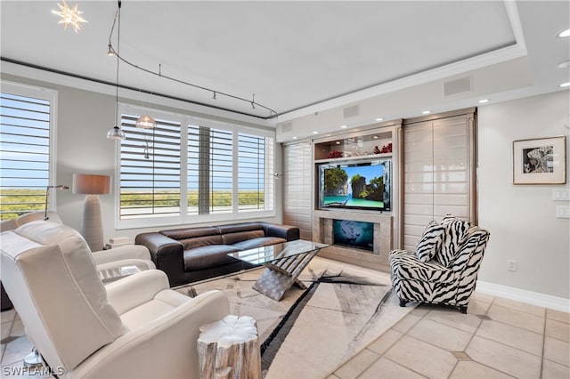 tiled living room featuring a high end fireplace and ornamental molding