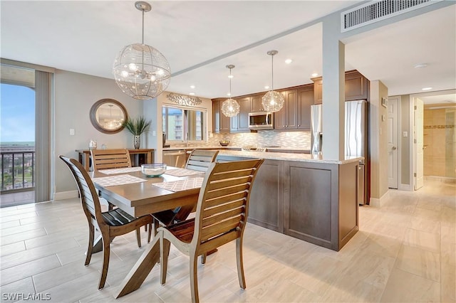 dining space with recessed lighting, a notable chandelier, baseboards, and visible vents