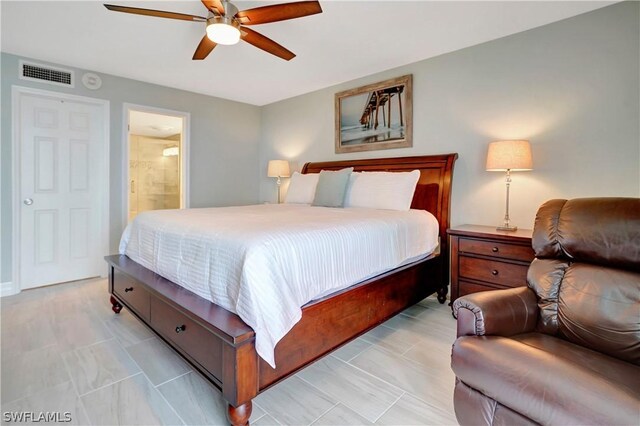 bedroom with ceiling fan, visible vents, and ensuite bathroom