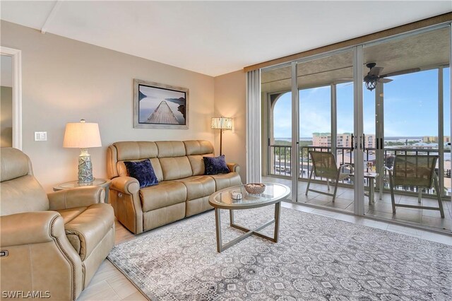 tiled living room featuring floor to ceiling windows and ceiling fan