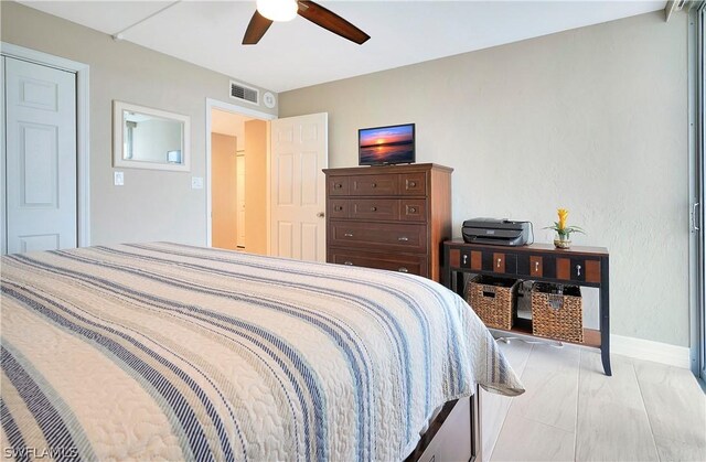 bedroom featuring ceiling fan, visible vents, and baseboards