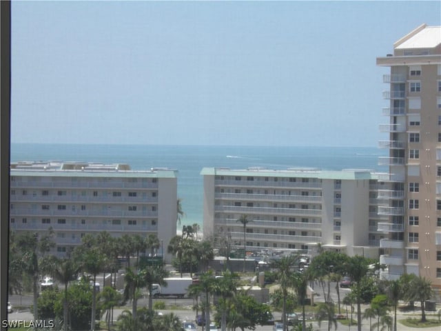 view of building exterior featuring a water view and a city view