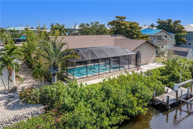 exterior space with a lanai, a patio area, a balcony, and a water view