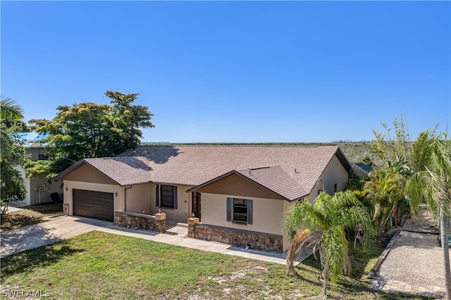 ranch-style home featuring a front yard and a garage