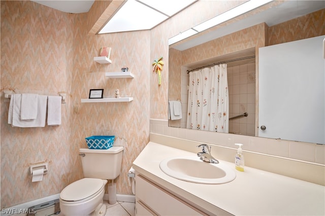 bathroom featuring tile floors, toilet, and large vanity