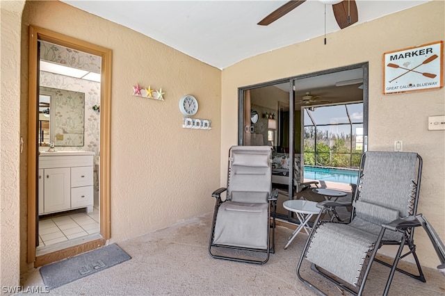 sunroom / solarium featuring ceiling fan