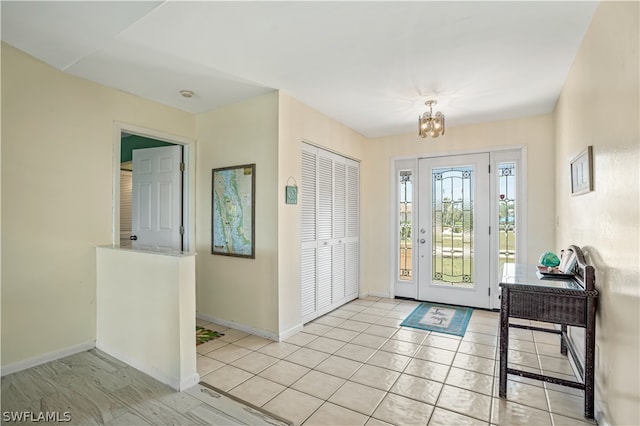 entrance foyer with a notable chandelier and light tile flooring