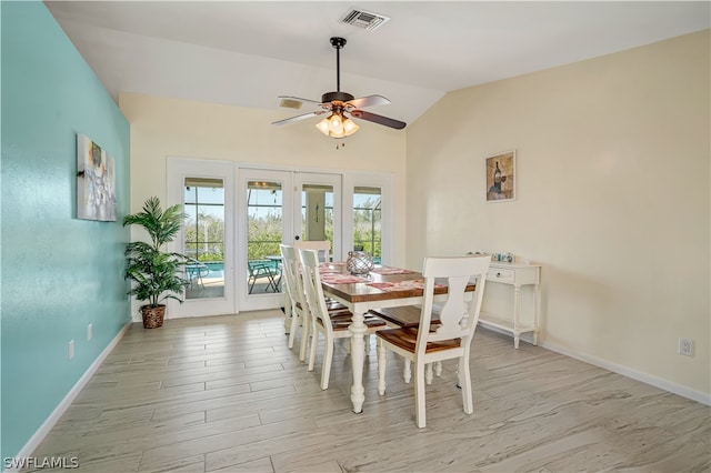 dining area featuring ceiling fan, french doors, lofted ceiling, and light wood-type flooring