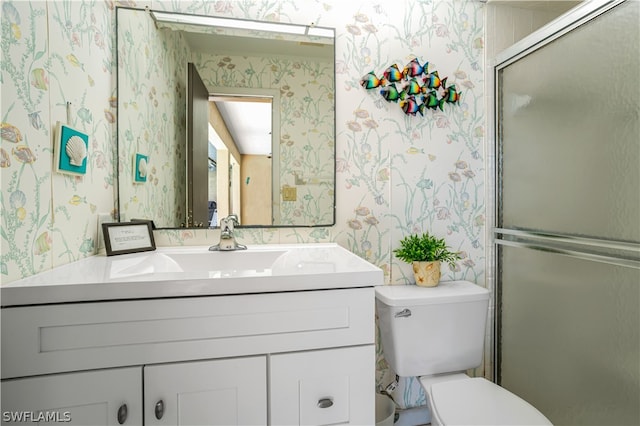 bathroom featuring an enclosed shower, oversized vanity, and toilet