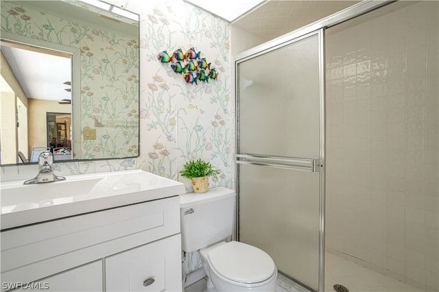 bathroom with an enclosed shower, large vanity, and toilet