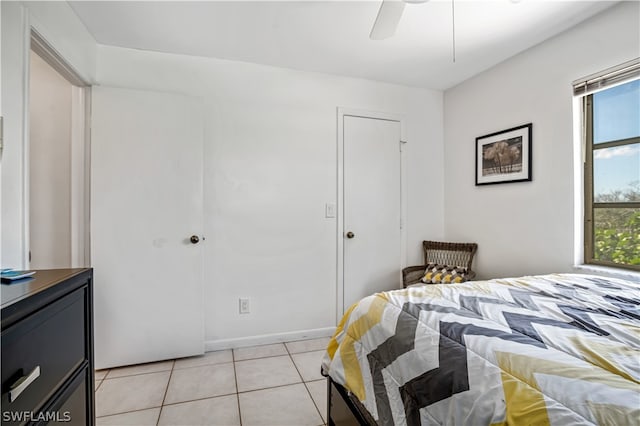 bedroom featuring ceiling fan and light tile floors