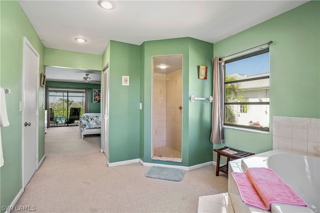 bathroom featuring ceiling fan and independent shower and bath