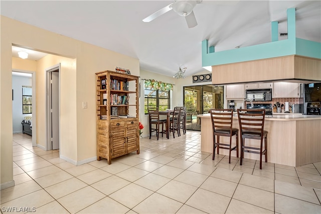 kitchen featuring a healthy amount of sunlight, backsplash, kitchen peninsula, and ceiling fan