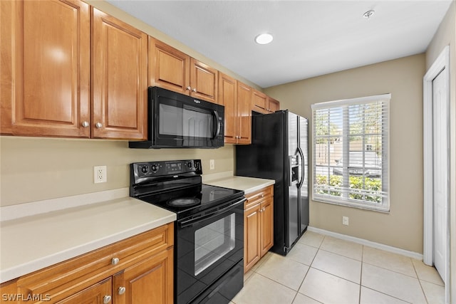 kitchen featuring light tile patterned floors and black appliances