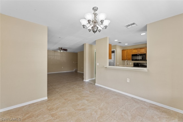 unfurnished room with sink and ceiling fan with notable chandelier