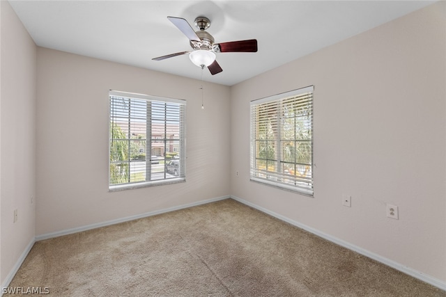 carpeted empty room with ceiling fan