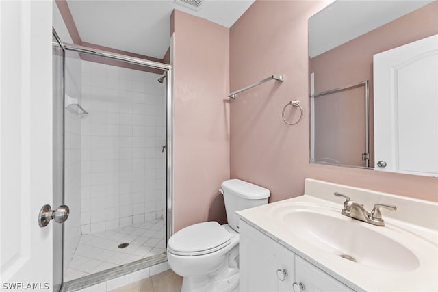 bathroom with walk in shower, vanity, toilet, and tile patterned flooring