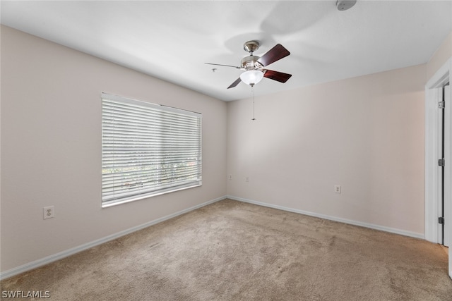 empty room with light carpet and ceiling fan