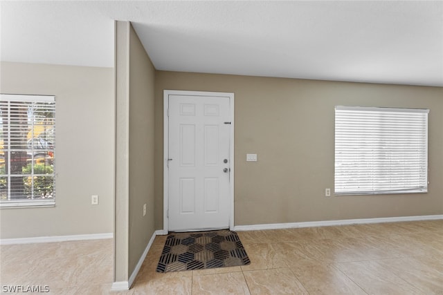 foyer entrance featuring light tile patterned floors