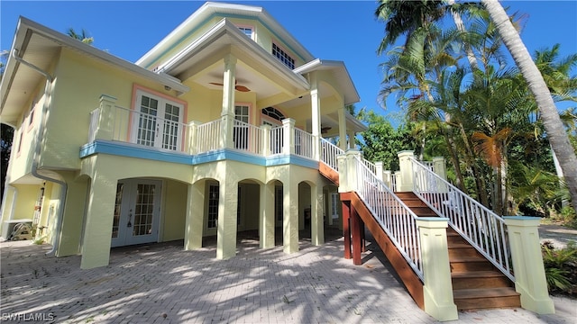 back of house with central AC unit