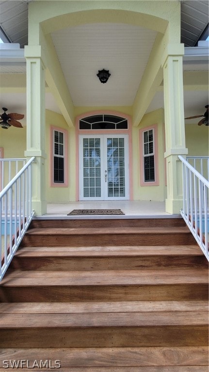 view of exterior entry featuring covered porch, ceiling fan, and french doors