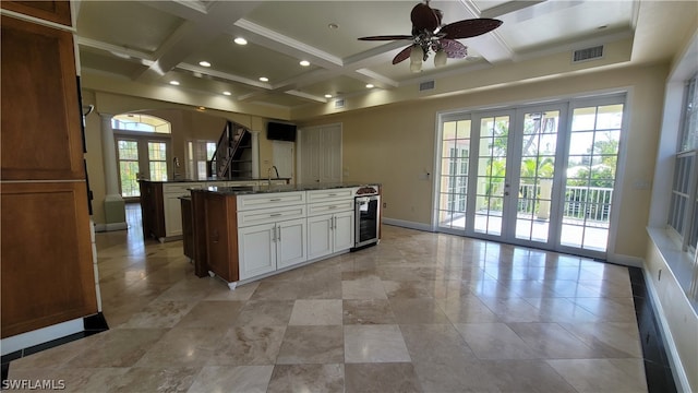 kitchen featuring ceiling fan, white cabinets, coffered ceiling, french doors, and light tile patterned floors