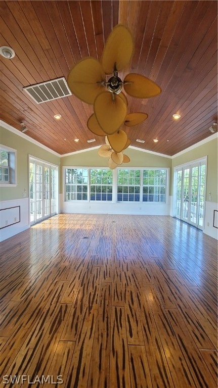 empty room with ornamental molding, hardwood / wood-style floors, and wood ceiling