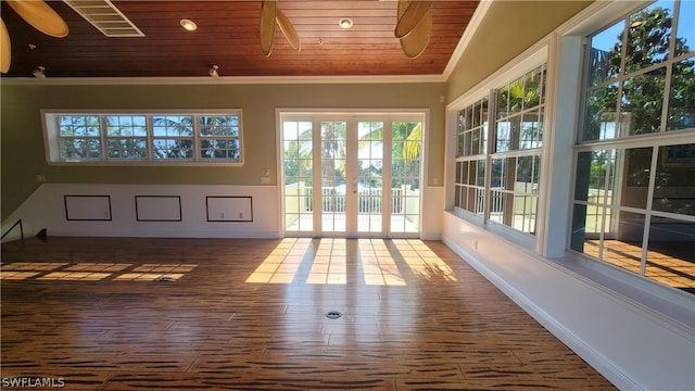 unfurnished sunroom featuring vaulted ceiling, wood ceiling, and ceiling fan