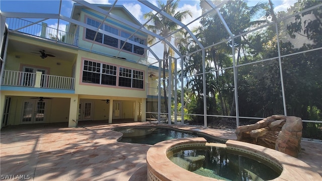 view of pool featuring an in ground hot tub, french doors, and ceiling fan