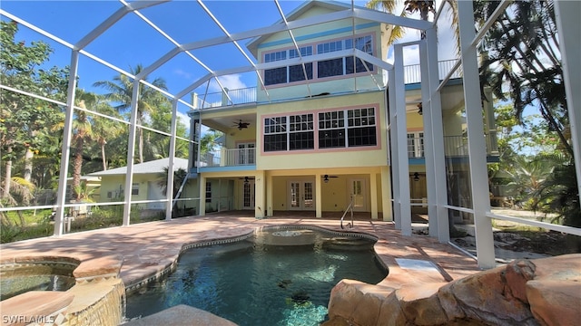 view of swimming pool featuring a patio area, an in ground hot tub, ceiling fan, and french doors