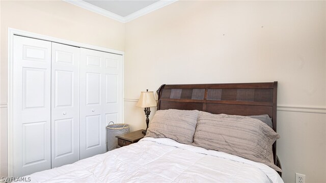 bedroom with a closet and ornamental molding