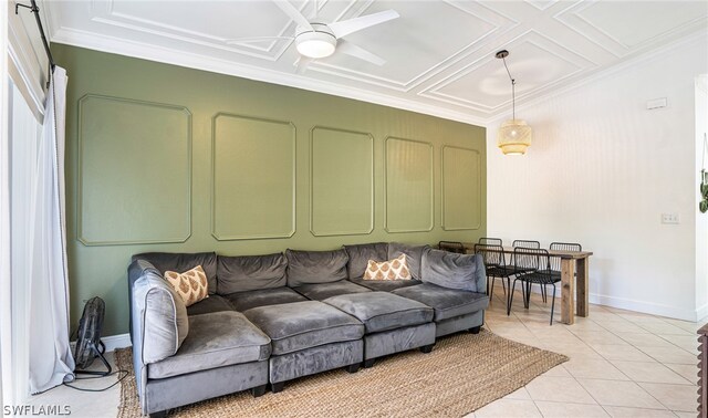 tiled living room with ceiling fan and crown molding