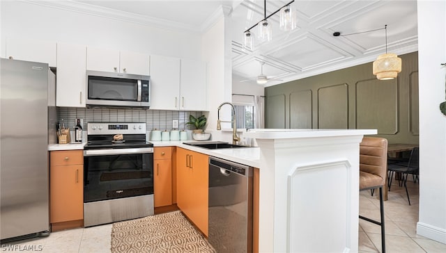 kitchen featuring white cabinetry, ceiling fan, pendant lighting, sink, and appliances with stainless steel finishes