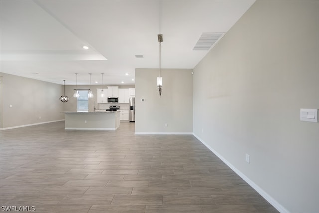 unfurnished living room with sink