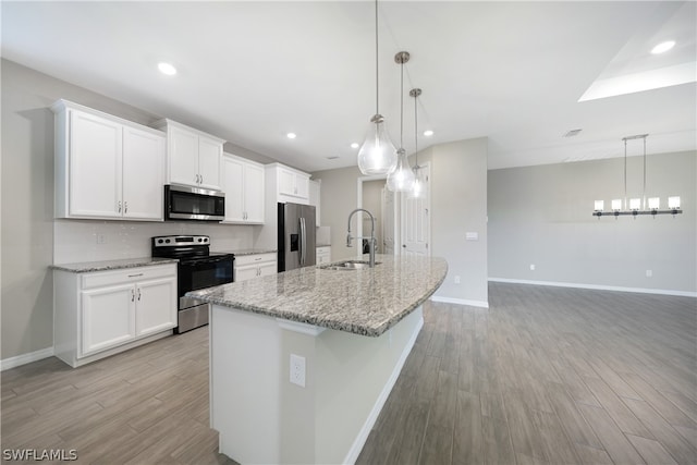 kitchen featuring appliances with stainless steel finishes, sink, white cabinets, and light wood-type flooring