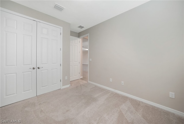 unfurnished bedroom featuring a closet and carpet