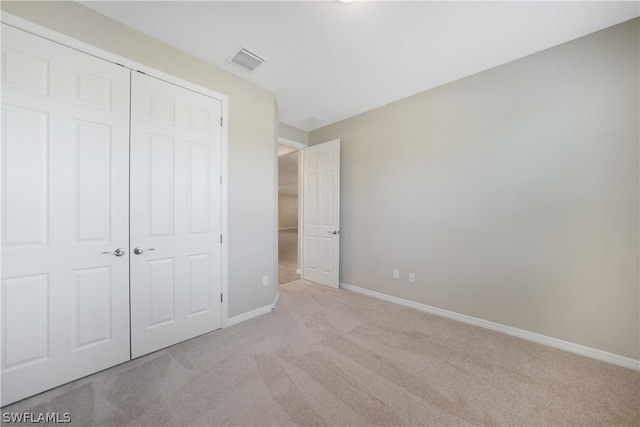 unfurnished bedroom featuring carpet and a closet