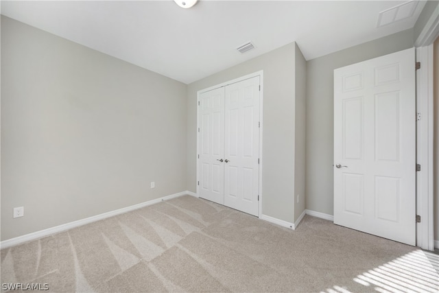 unfurnished bedroom with carpet and a closet