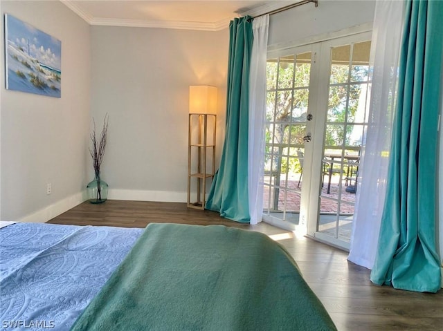 bedroom featuring access to exterior, dark hardwood / wood-style flooring, french doors, and crown molding