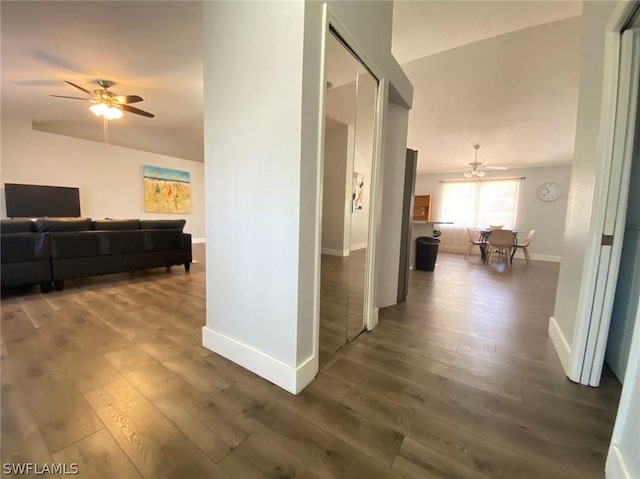 hallway with vaulted ceiling and hardwood / wood-style flooring