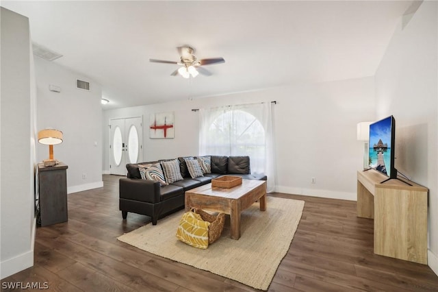 living room featuring ceiling fan, dark hardwood / wood-style flooring, and french doors