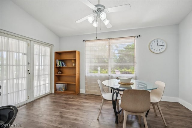 dining area with french doors, ceiling fan, vaulted ceiling, and dark hardwood / wood-style floors