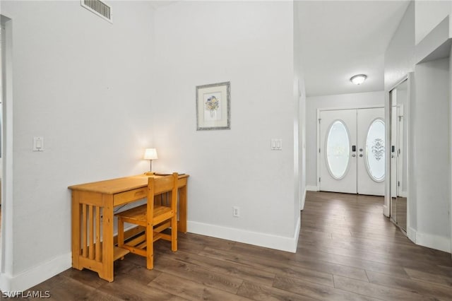 foyer entrance with dark wood-type flooring and french doors