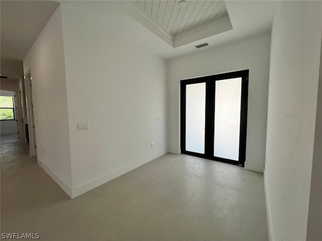 empty room featuring a raised ceiling