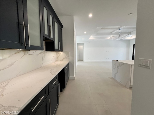 kitchen with backsplash and light stone countertops