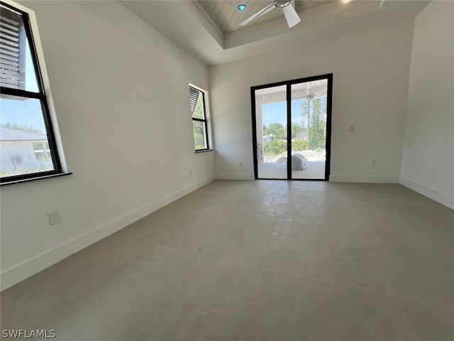 unfurnished room featuring ceiling fan and plenty of natural light