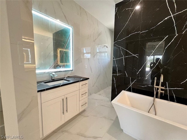 bathroom with vanity, tile walls, and a bathing tub