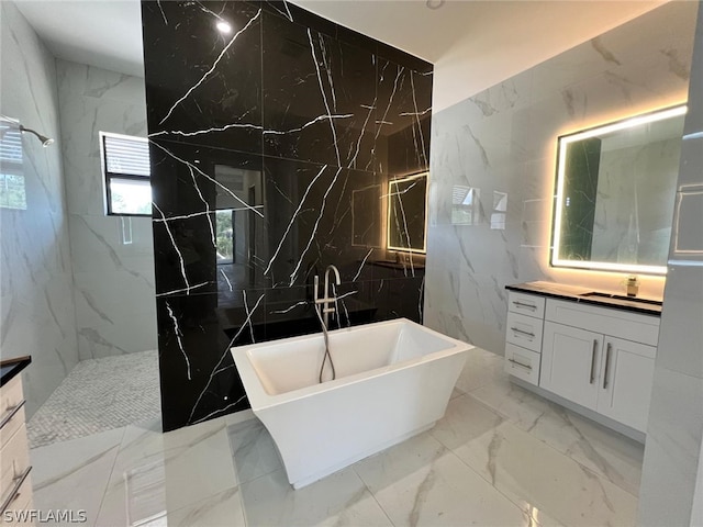 bathroom featuring vanity, tile walls, and shower with separate bathtub