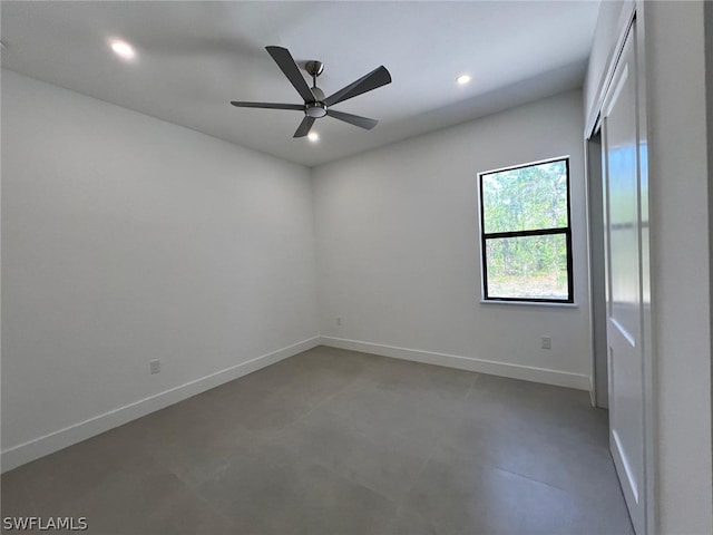 empty room with concrete flooring and ceiling fan