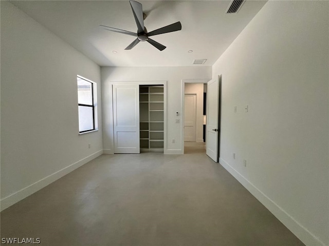 unfurnished bedroom featuring a closet, a spacious closet, and ceiling fan